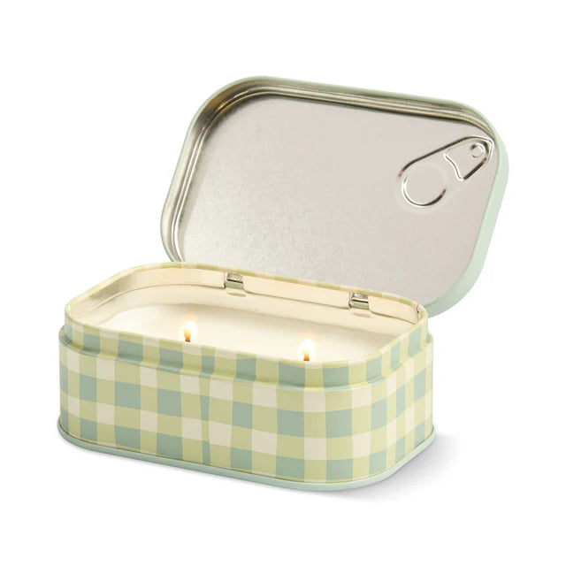 A Paddywax Macaron soy wax candle in a mint green tin with pink and pastel macaron illustrations and a silver pull tab, shown on a light gray background.