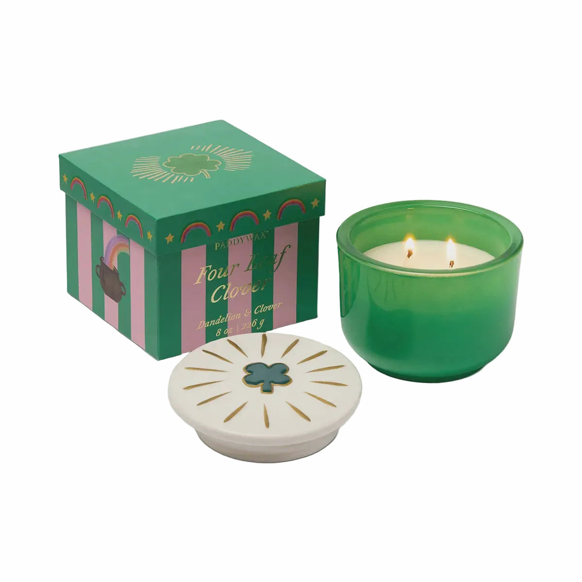 Green candle with decorative box and lid on a white background