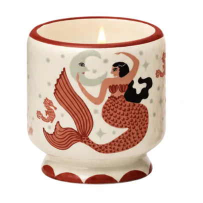 Mermaid-themed candle with matching packaging on a white background