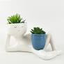 Kinky Person Holding a Pot Planter